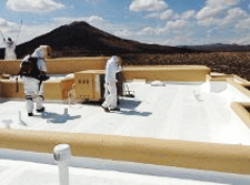 Meraz Painting applying elastomeric roof coating in Las Cruces