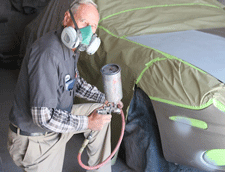 Painting a car at Litzenberg Auto Body Shop in Las Cruces